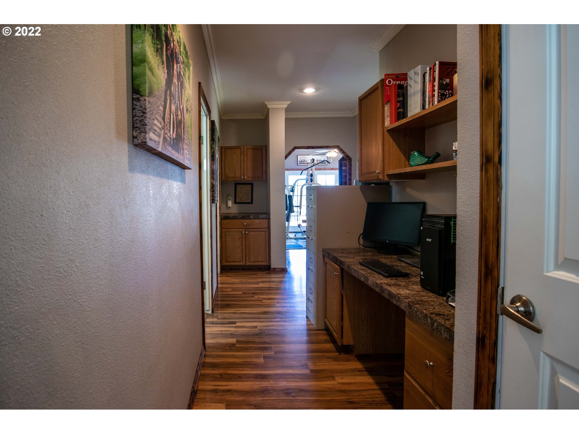 1578 Scholfield Road Reedsport, OR 97467 - Photo 16 of 37 a view of a workspace with furniture and wooden floor