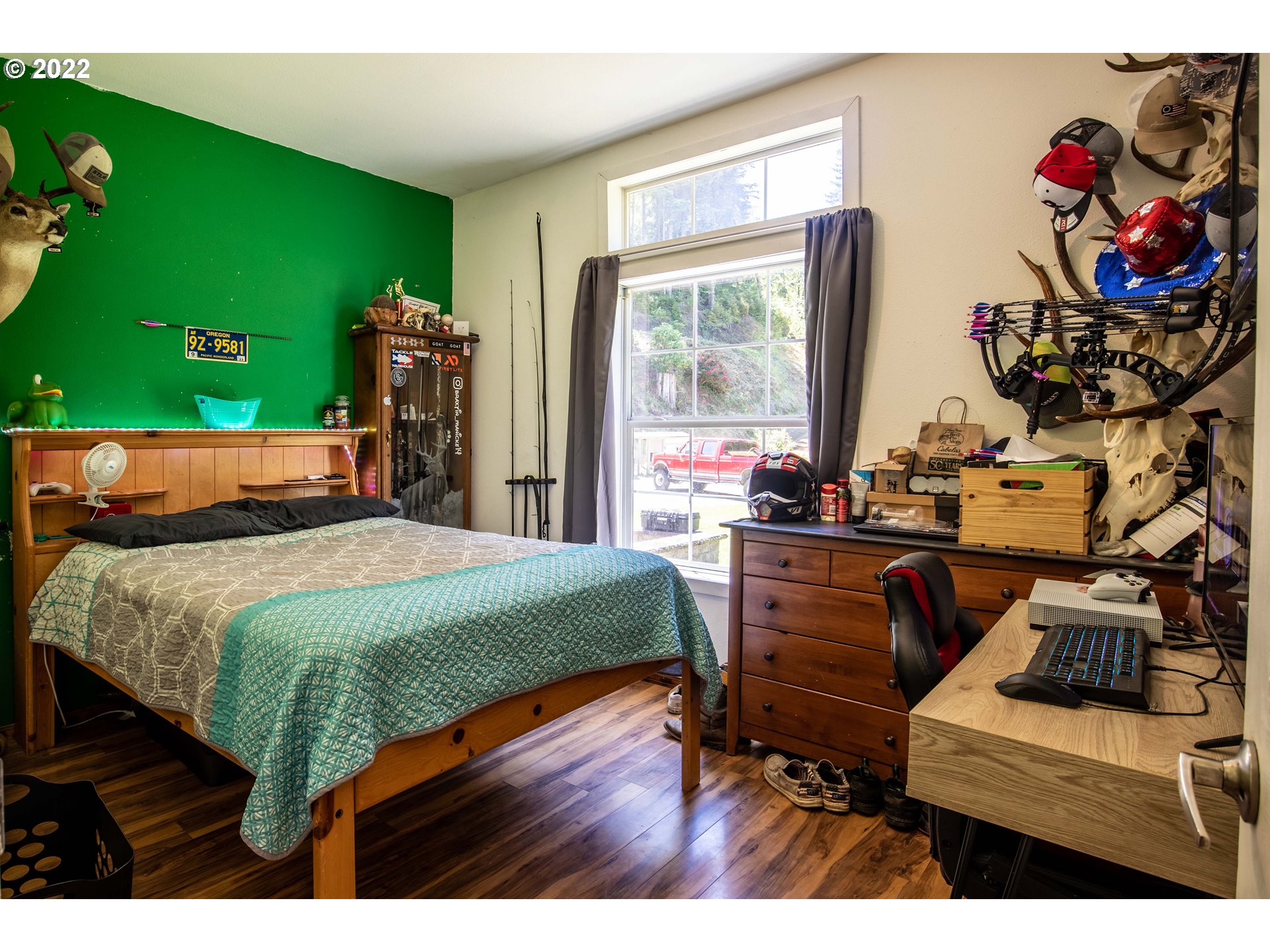 1578 Scholfield Road Reedsport, OR 97467 - Photo 17 of 37 a bed sitting in a bedroom next to a window