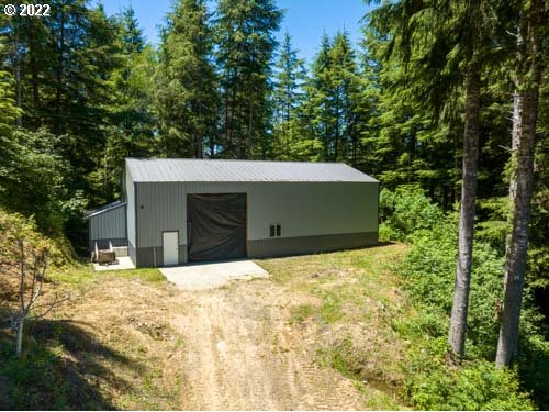 1578 Scholfield Road Reedsport, OR 97467 - Photo 23 of 37 a house with trees in front of it