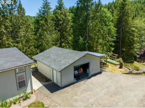 1578 Scholfield Road Reedsport, OR 97467 - Photo 32 of 37 an aerial view of a house with yard barbeque oven and outdoor seating