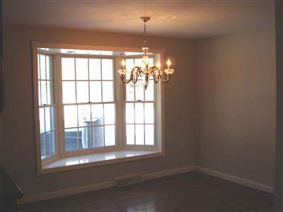 1520 Old Post Road Marstons Mills, MA 02648 - Photo 9 of 20 a room with a chandelier and large windows