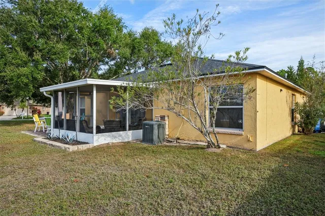 a view of a small house with wooden fence
