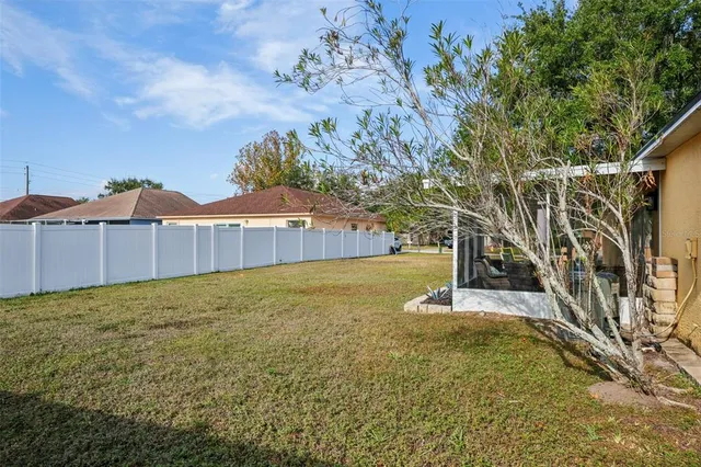 a view of a backyard with basketball court