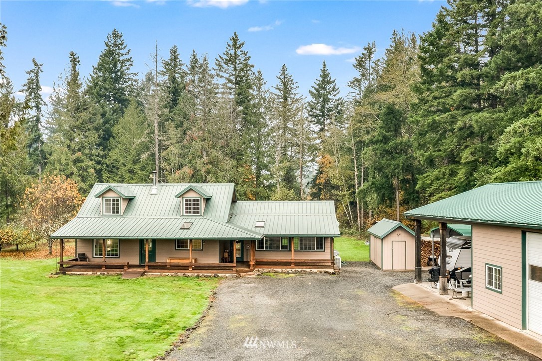 454 Harmon Road, Unit 26 Chehalis, WA 98532 - Photo 32 of 35 a view of a white house with a big yard and large trees
