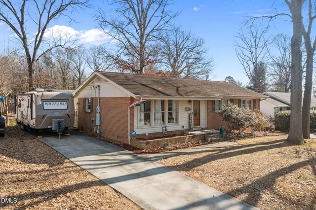 a view of a house with a yard covered in snow