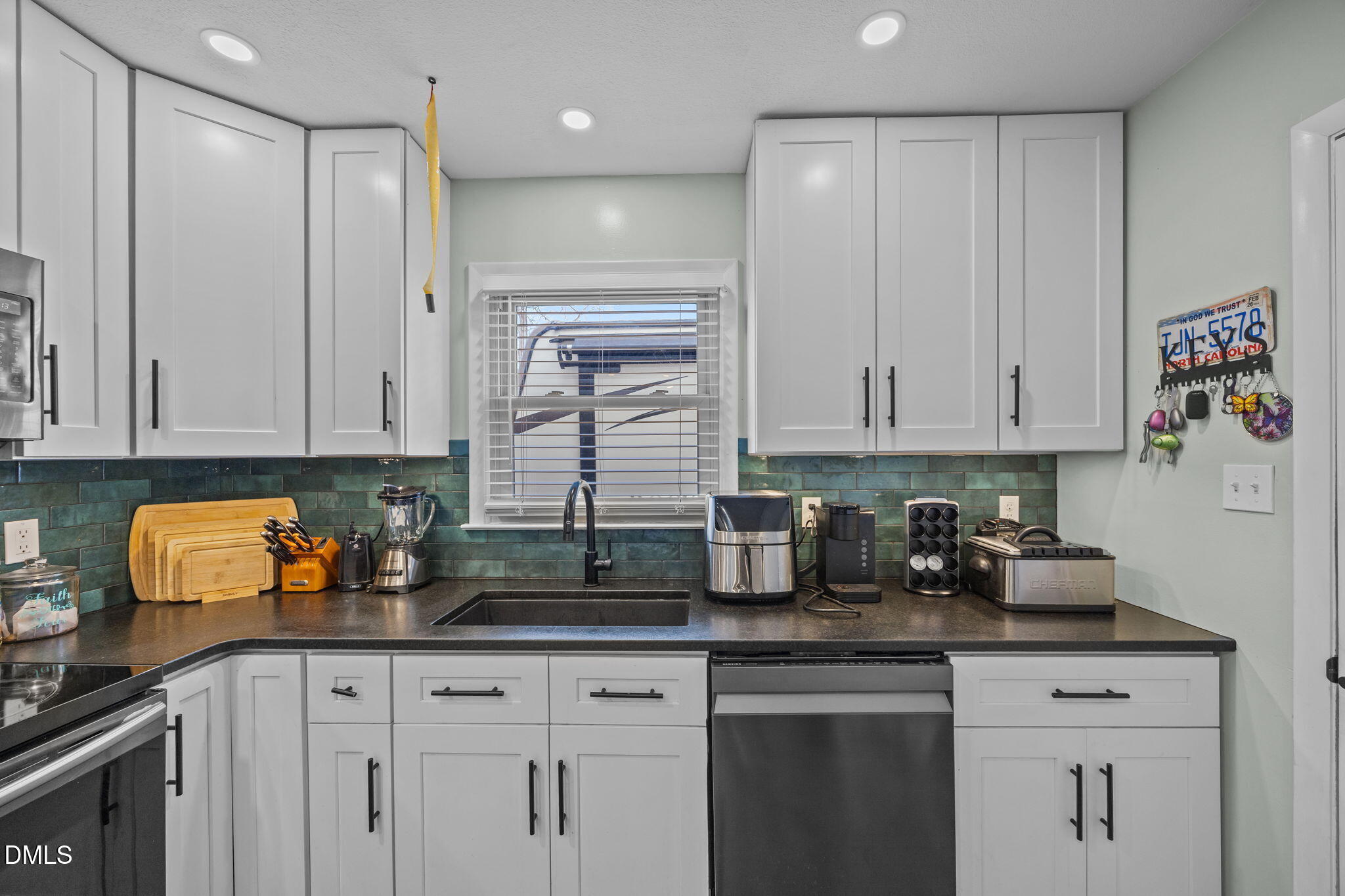 317 Clapp Street Graham, NC 27253 - Photo 11 of 33 a kitchen with stainless steel appliances granite countertop a sink a stove and a granite counter tops