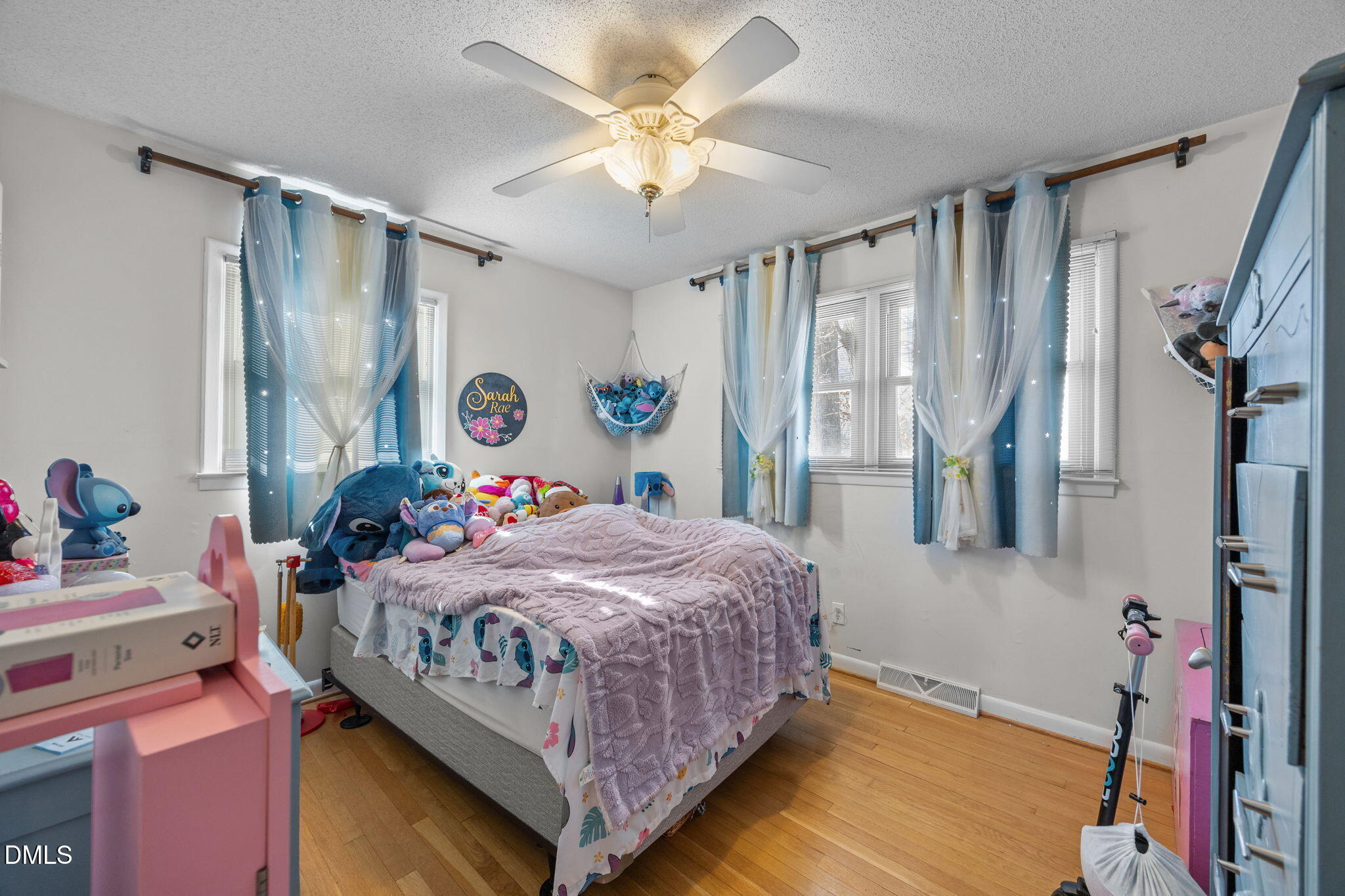317 Clapp Street Graham, NC 27253 - Photo 19 of 33 a bedroom with a bed and a chandelier