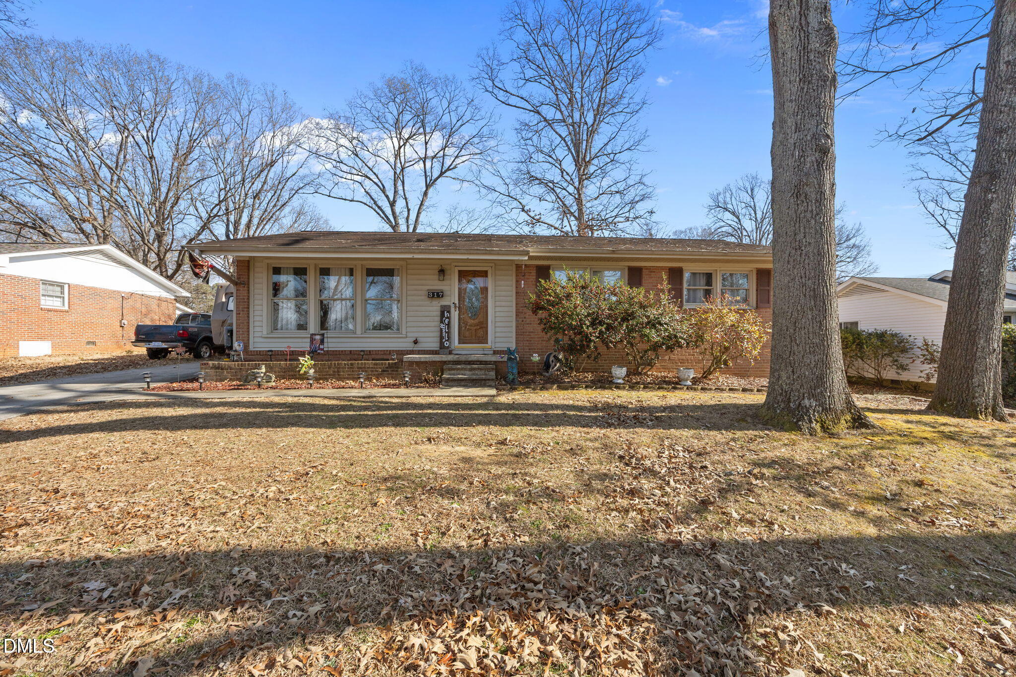 317 Clapp Street Graham, NC 27253 - Photo 2 of 33 a view of a house with a yard covered with snow in front of house