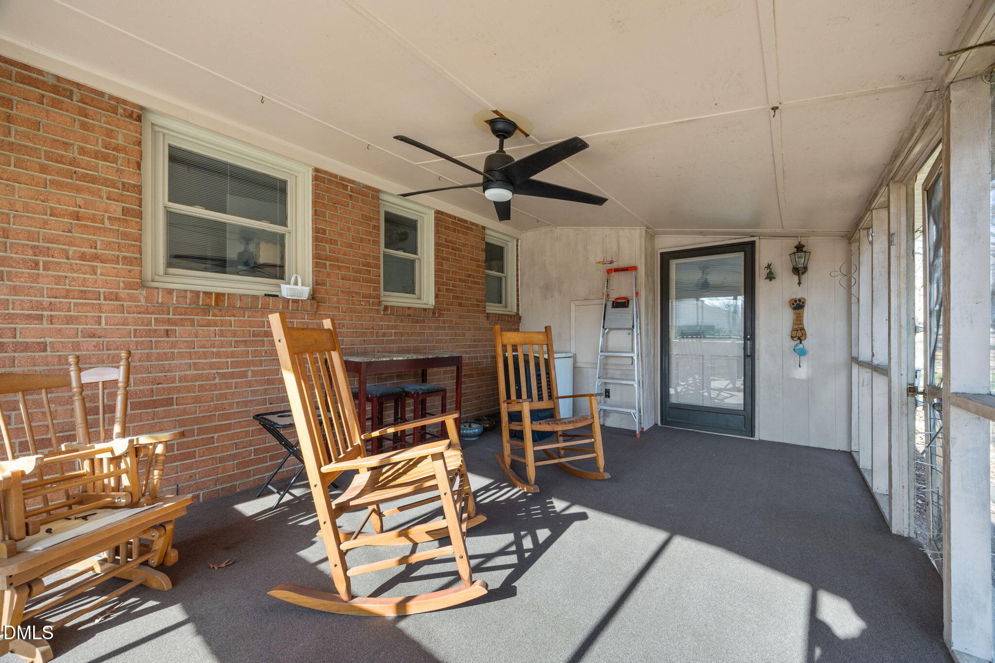 317 Clapp Street Graham, NC 27253 - Photo 4 of 33 a living room with furniture a flat screen tv and a fireplace