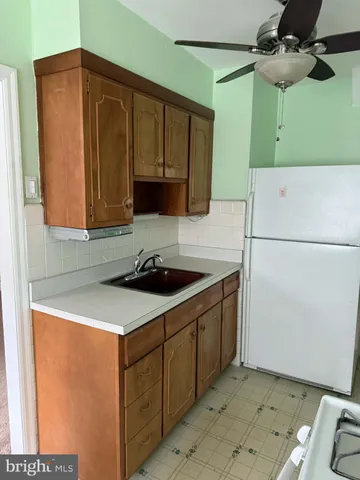 a kitchen with a sink and a refrigerator