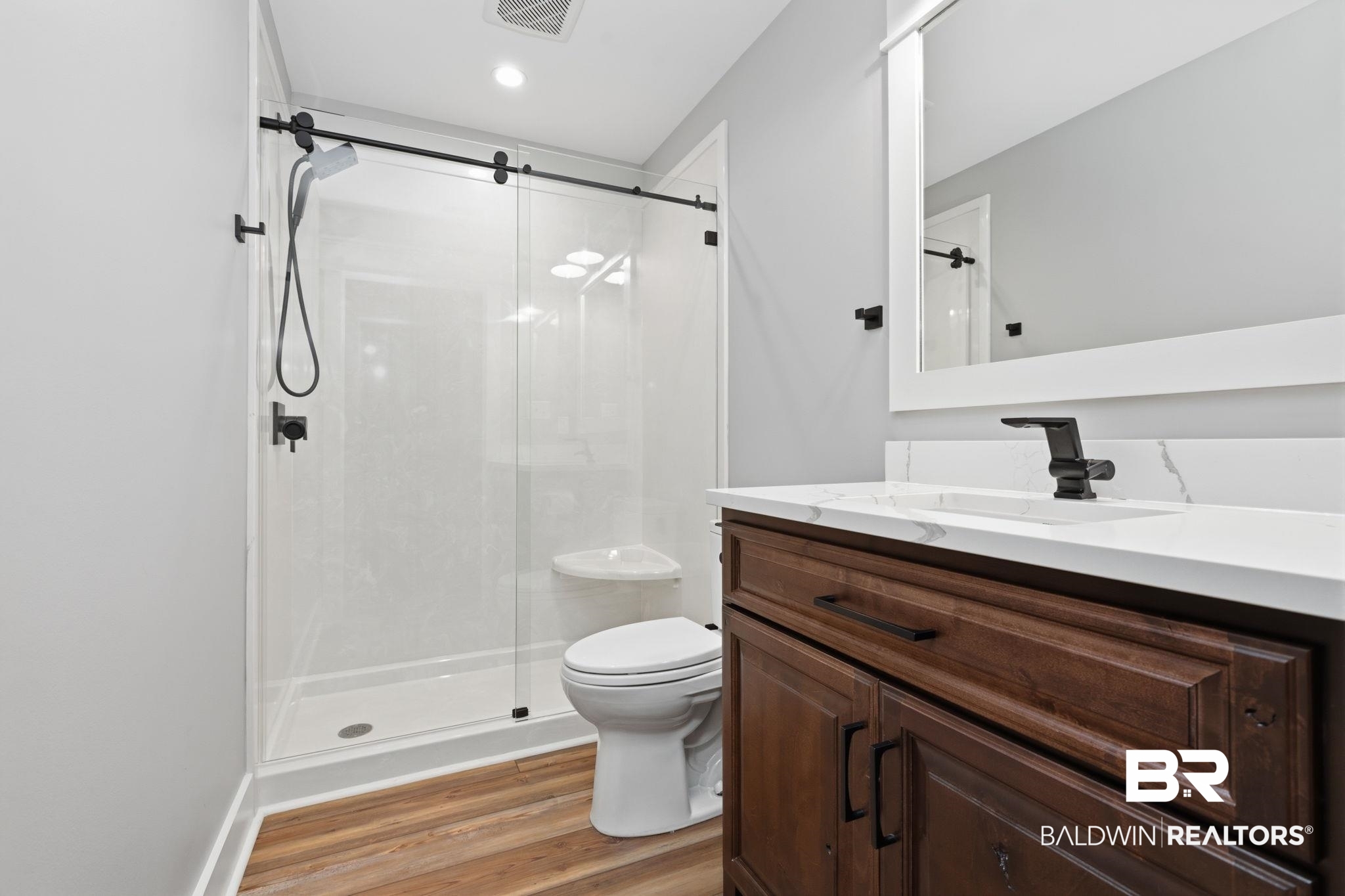 9501 Ben Hamilton Road Theodore, AL 36582 - Photo 50 of 69 Bathroom featuring vanity, a stall shower, light wood-style flooring, and recessed lighting