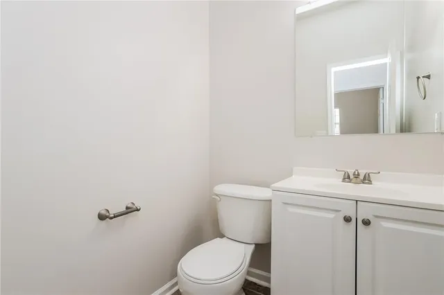 a white toilet sitting next to a bathroom sink