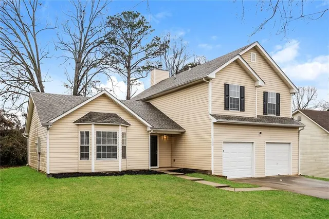 a front view of a house with a yard