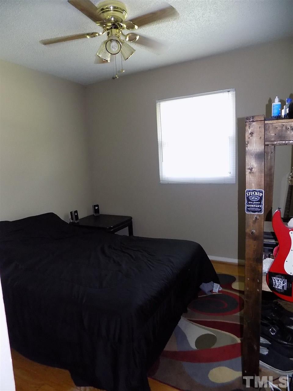 1319 Kelly Road Garner, NC 27529 - Photo 22 of 25 a bed sitting in a bedroom next to a window