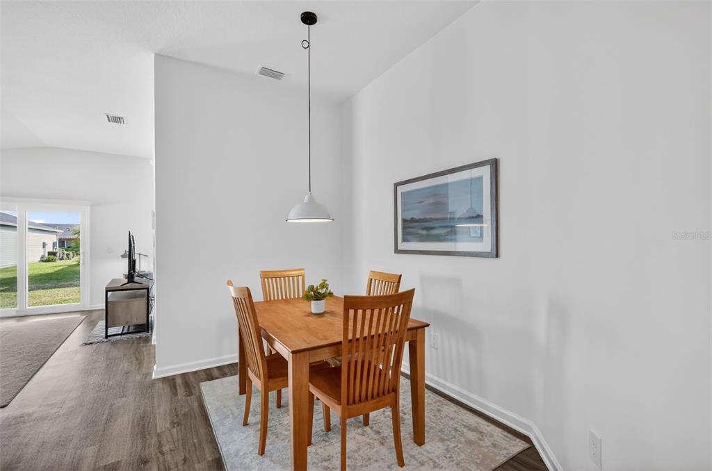 832 Conroe Street The Villages, FL 34762 - Photo 14 of 37 a dining room with furniture and wooden floor