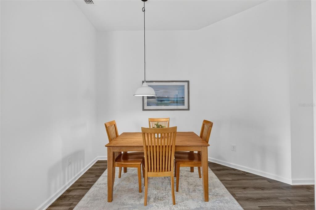 832 Conroe Street The Villages, FL 34762 - Photo 15 of 37 a dining room with furniture and wooden floor