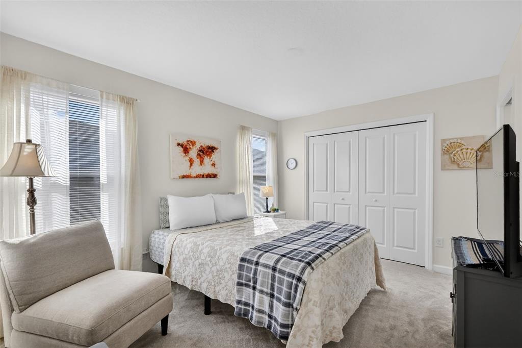 832 Conroe Street The Villages, FL 34762 - Photo 16 of 37 a bedroom with a bed a couch and a large window