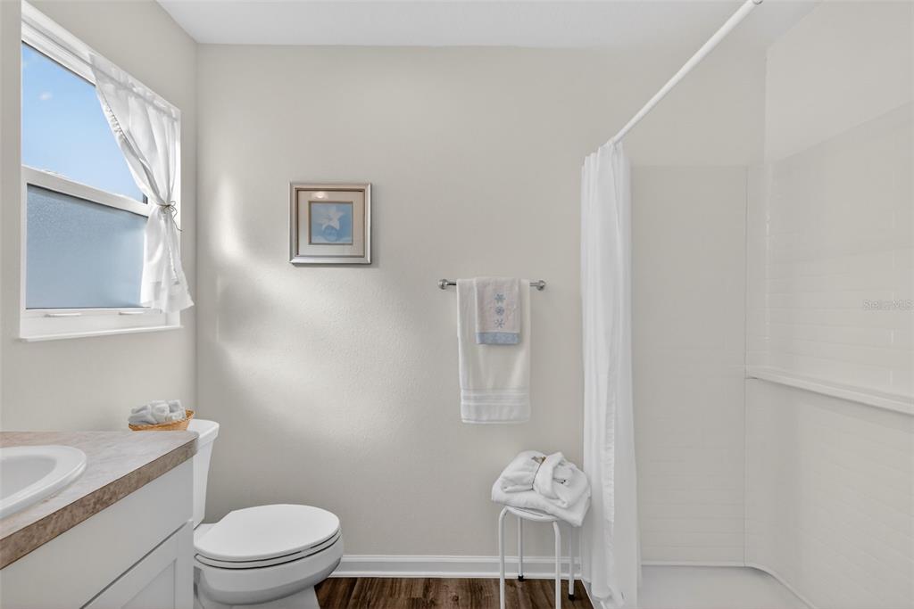 832 Conroe Street The Villages, FL 34762 - Photo 19 of 37 a bathroom with a granite countertop toilet and a sink