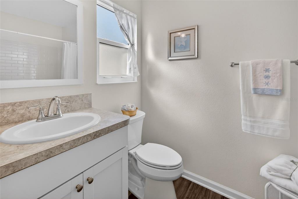 832 Conroe Street The Villages, FL 34762 - Photo 20 of 37 a bathroom with a granite countertop sink mirror vanity and toilet