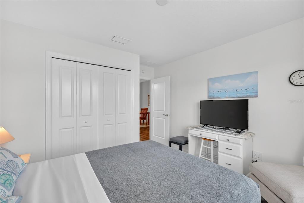 832 Conroe Street The Villages, FL 34762 - Photo 23 of 37 a view of a bedroom with workspace and mirror