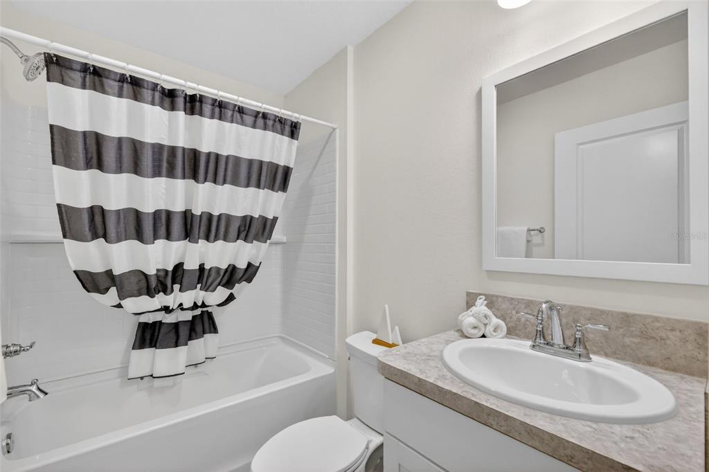 832 Conroe Street The Villages, FL 34762 - Photo 24 of 37 a bathroom with a sink a toilet a mirror and shower