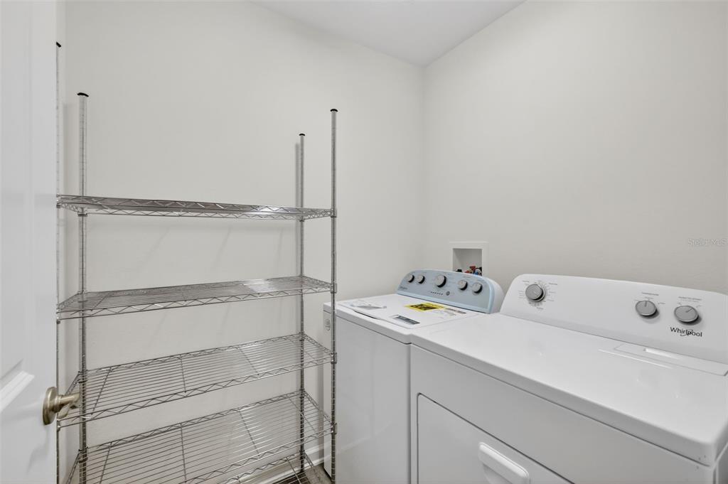 832 Conroe Street The Villages, FL 34762 - Photo 25 of 37 a utility room with dryer and washer