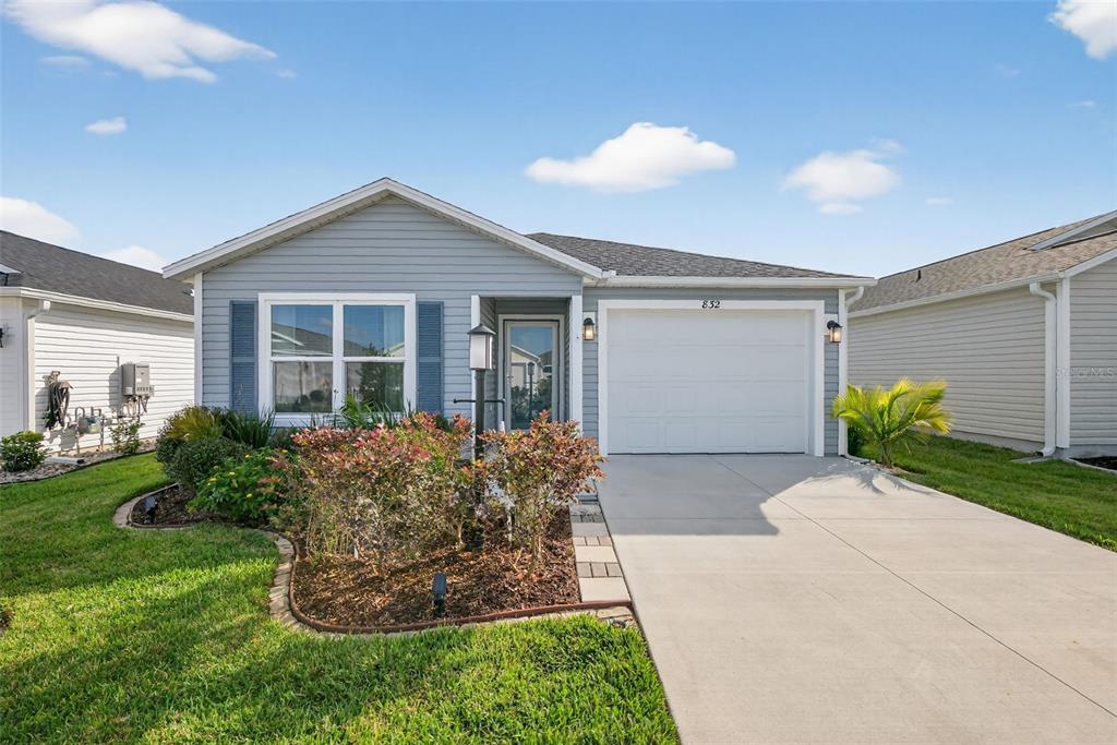 832 Conroe Street The Villages, FL 34762 - Photo 29 of 37 a front view of a house with garden