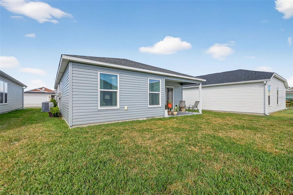 832 Conroe Street The Villages, FL 34762 - Photo 31 of 37 a backyard of a house with lots of green space