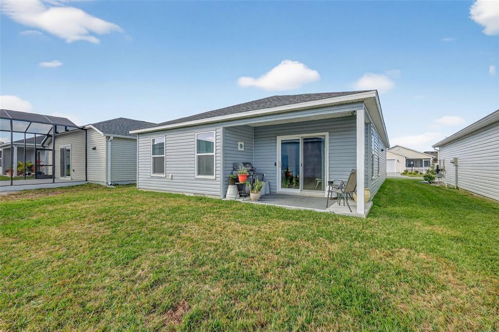 832 Conroe Street The Villages, FL 34762 - Photo 32 of 37 a view of a house with a backyard
