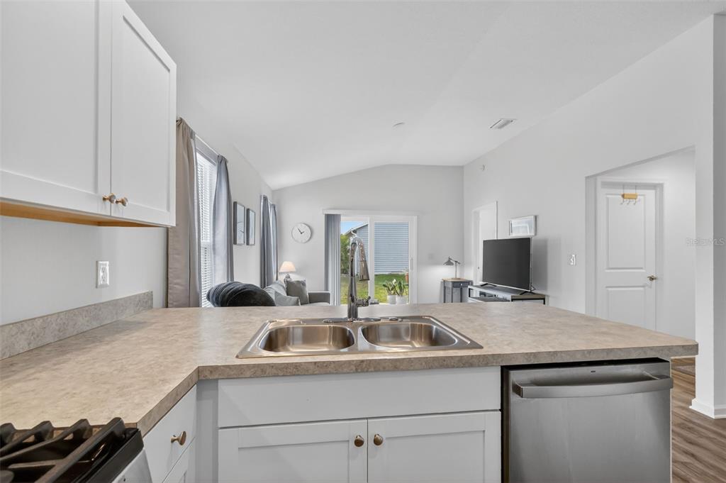 832 Conroe Street The Villages, FL 34762 - Photo 7 of 37 a kitchen with granite countertop a sink and a stove top oven