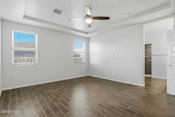 a view of an empty room and wooden floor