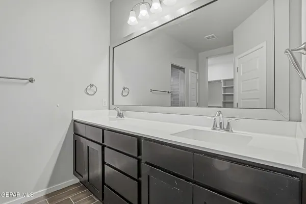 a bathroom with a double vanity sink and a mirror