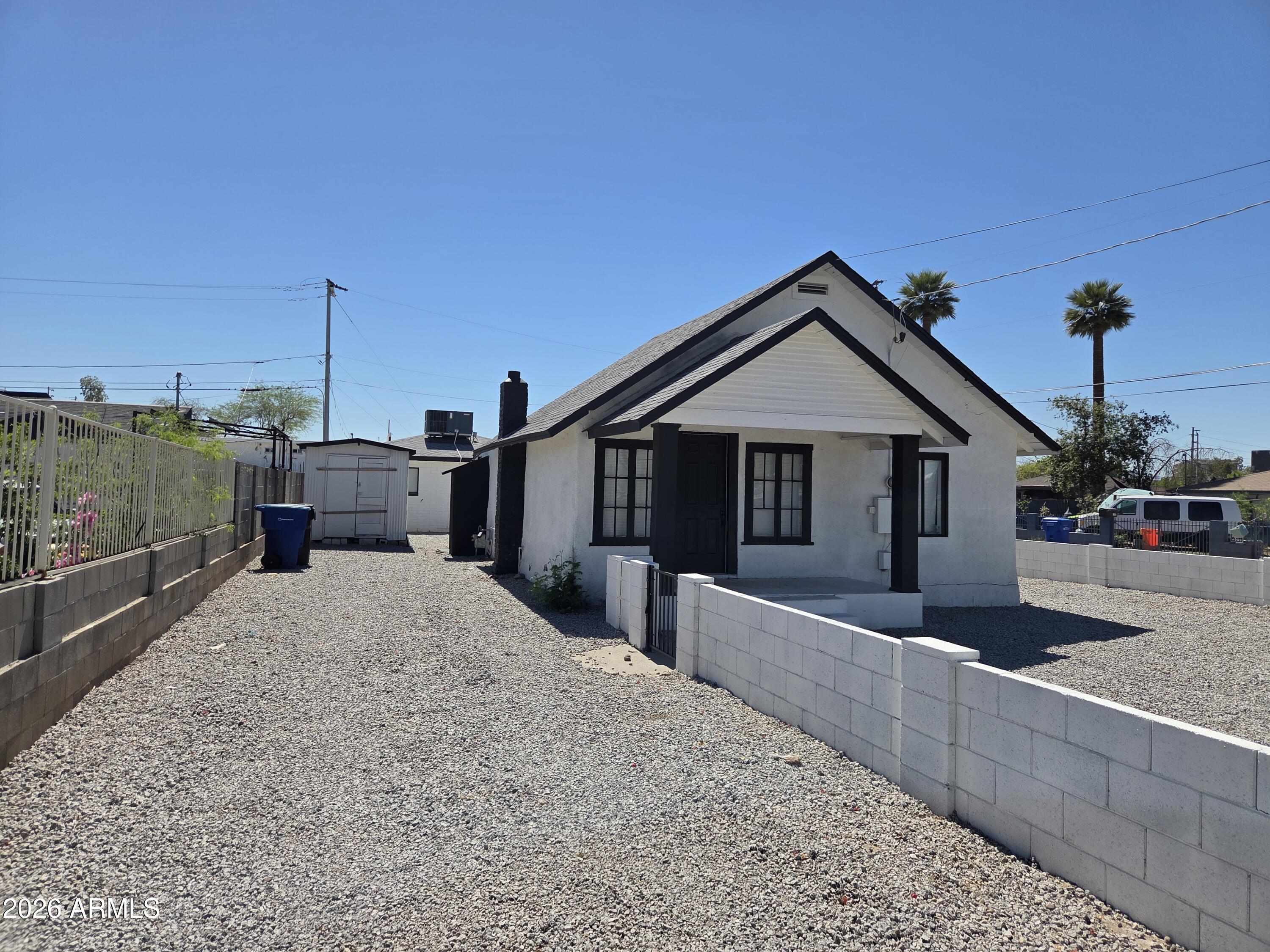 2201 East Portland Street Phoenix, AZ 85006 - Photo 3 of 11 a front view of a house with a porch