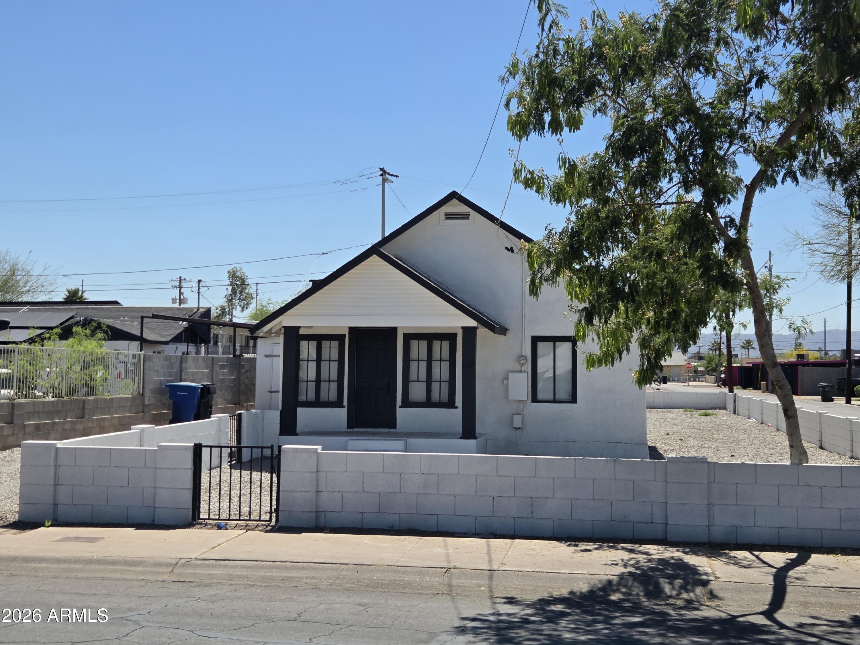 2201 East Portland Street Phoenix, AZ 85006 - Photo 4 of 11 a front view of a house with a garage