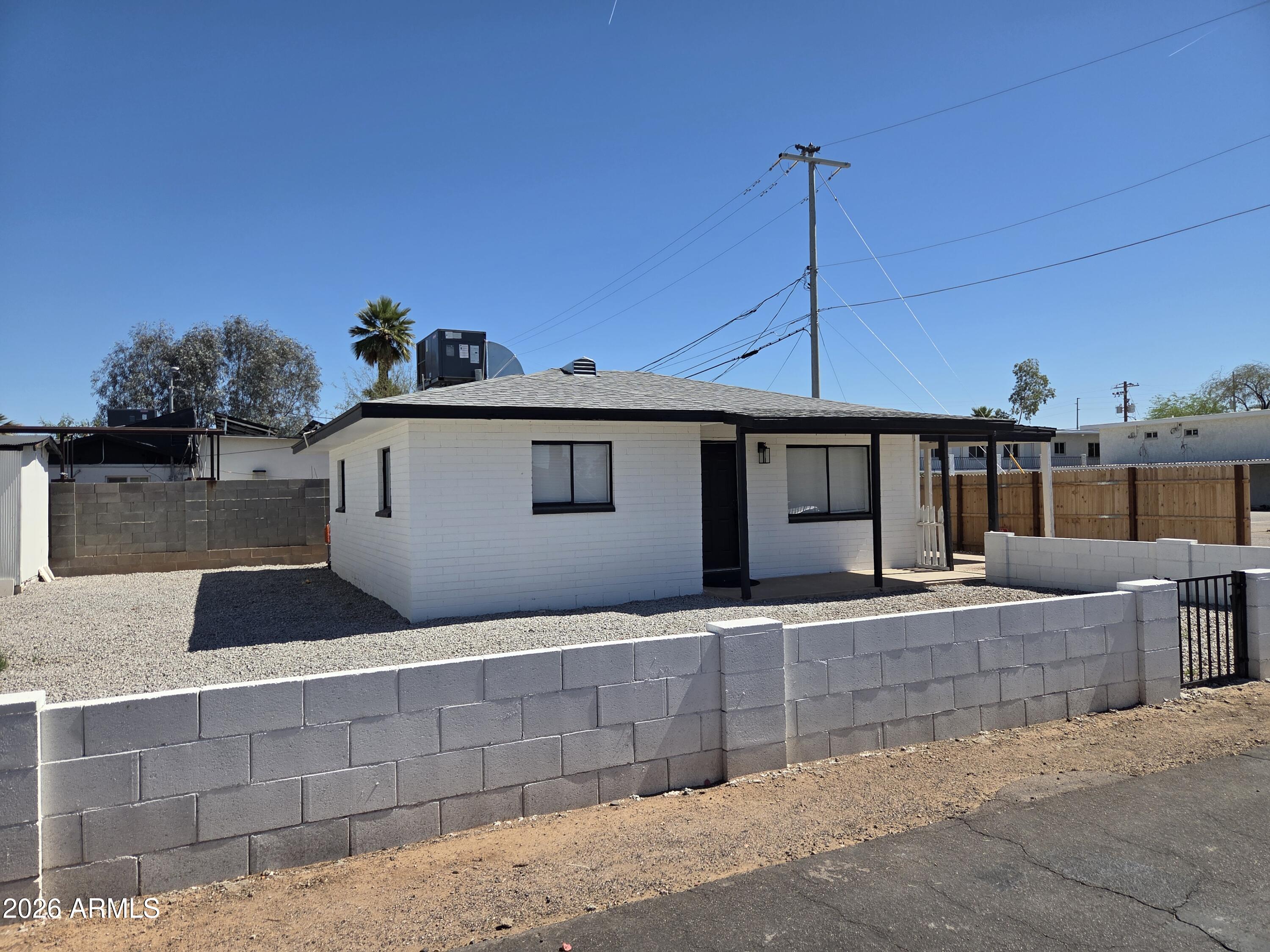 2201 East Portland Street Phoenix, AZ 85006 - Photo 5 of 11 a front view of a house with a porch