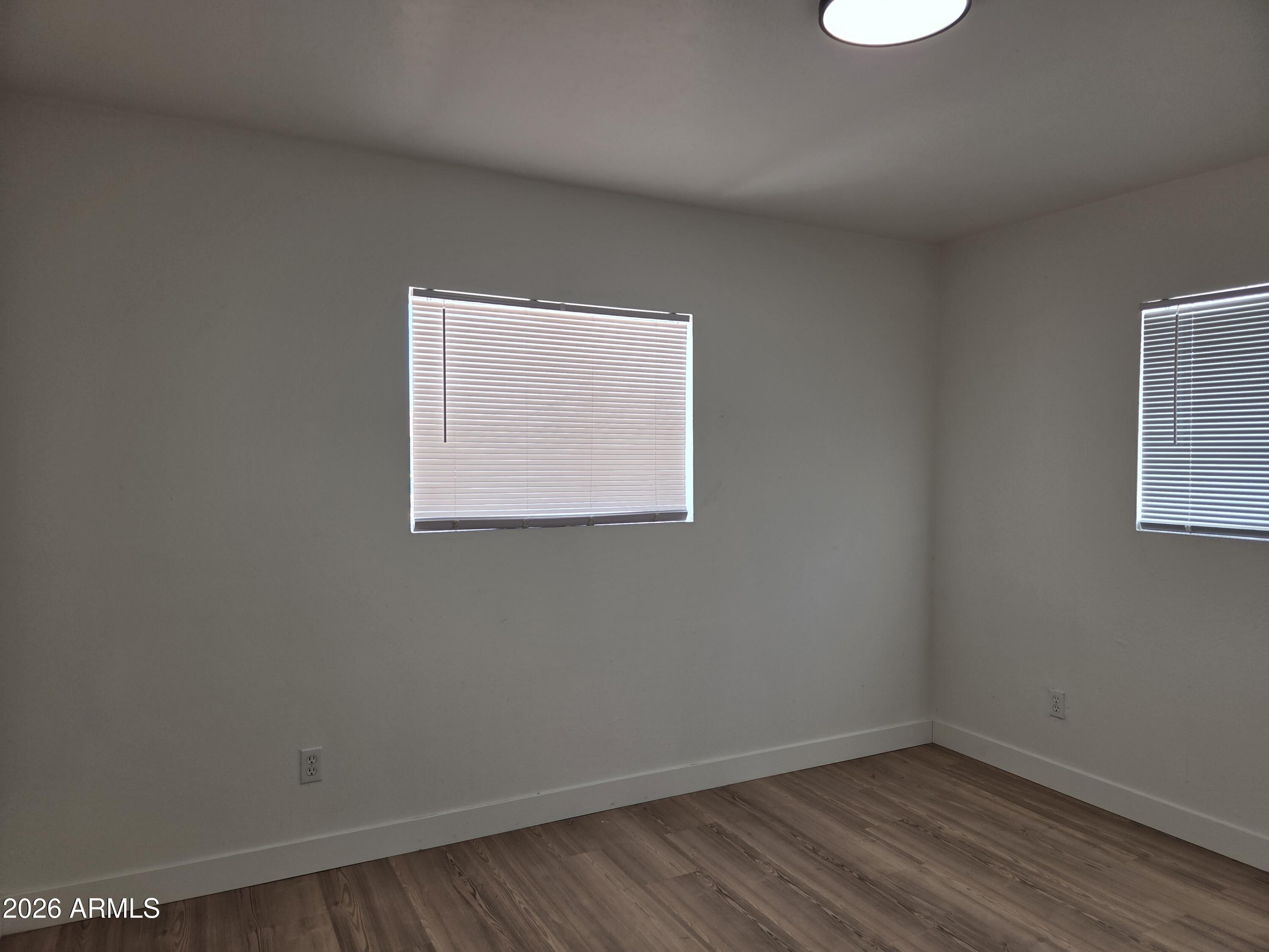 2201 East Portland Street Phoenix, AZ 85006 - Photo 8 of 11 an empty room with a window