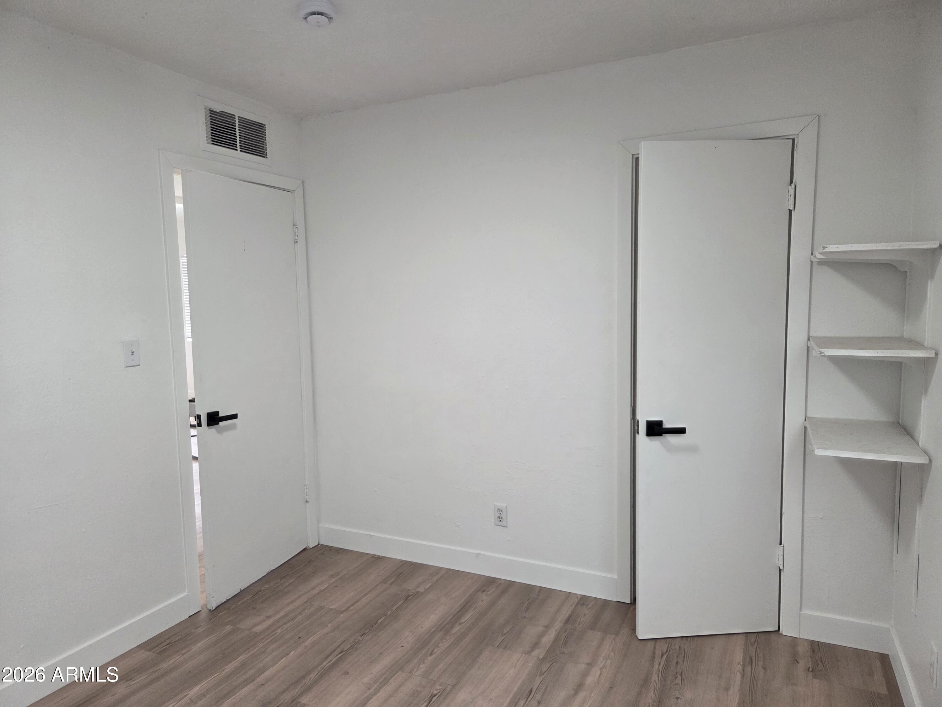 2201 East Portland Street Phoenix, AZ 85006 - Photo 10 of 11 a view of an empty room with wooden floor