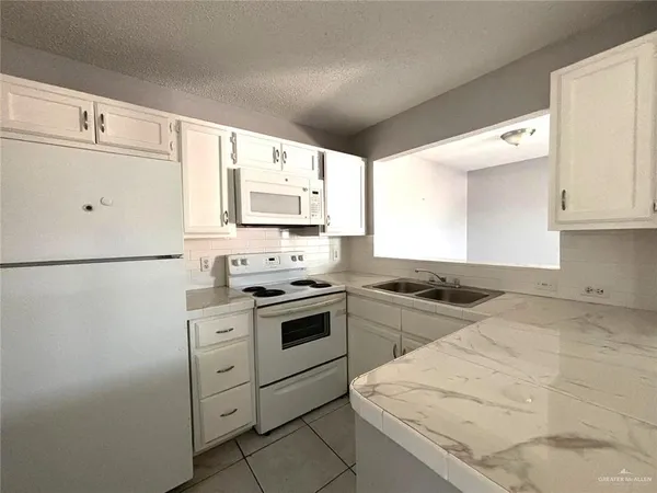 a kitchen with stainless steel appliances granite countertop a stove and a refrigerator