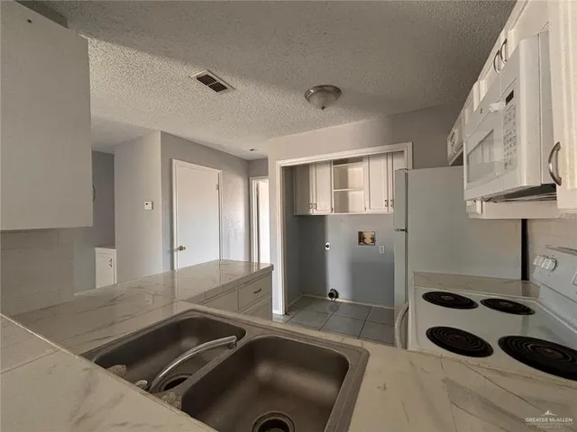 a kitchen with a sink and a refrigerator