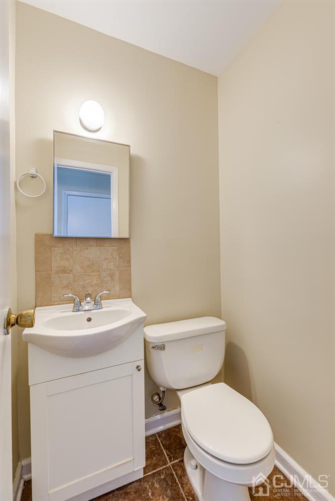 799 New Dover Road Edison, NJ 08820 - Photo 15 of 54 a white toilet sitting next to a bathroom sink