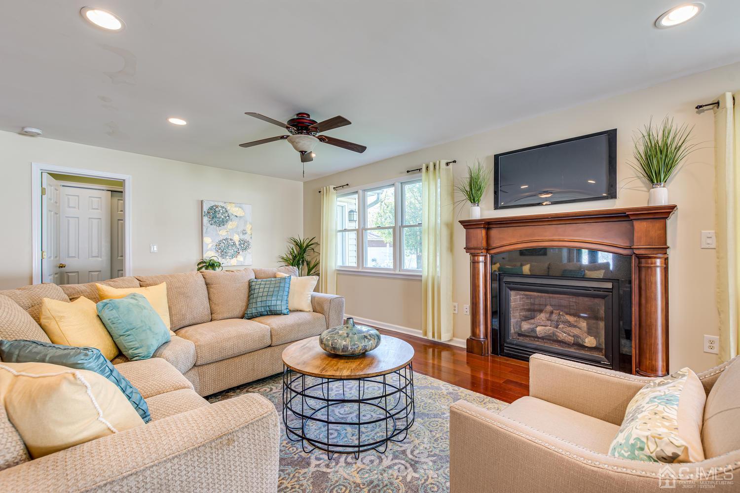 799 New Dover Road Edison, NJ 08820 - Photo 19 of 54 a living room with furniture a window and a fireplace