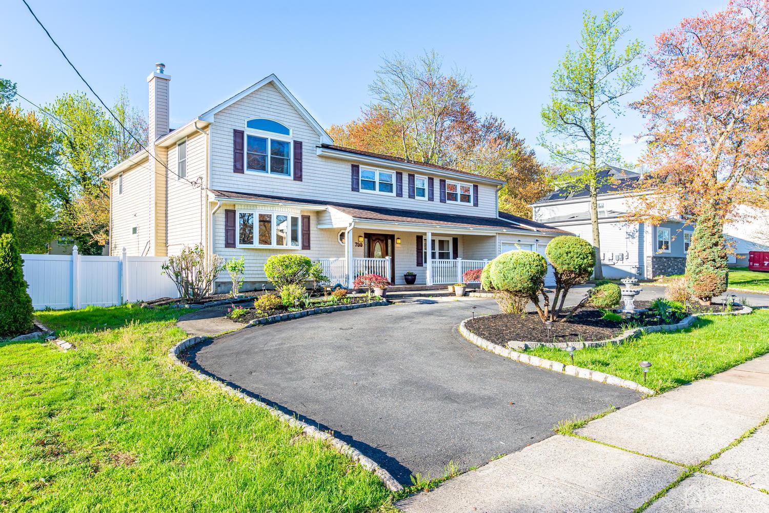 799 New Dover Road Edison, NJ 08820 - Photo 3 of 54 a front view of a house with garden and porch