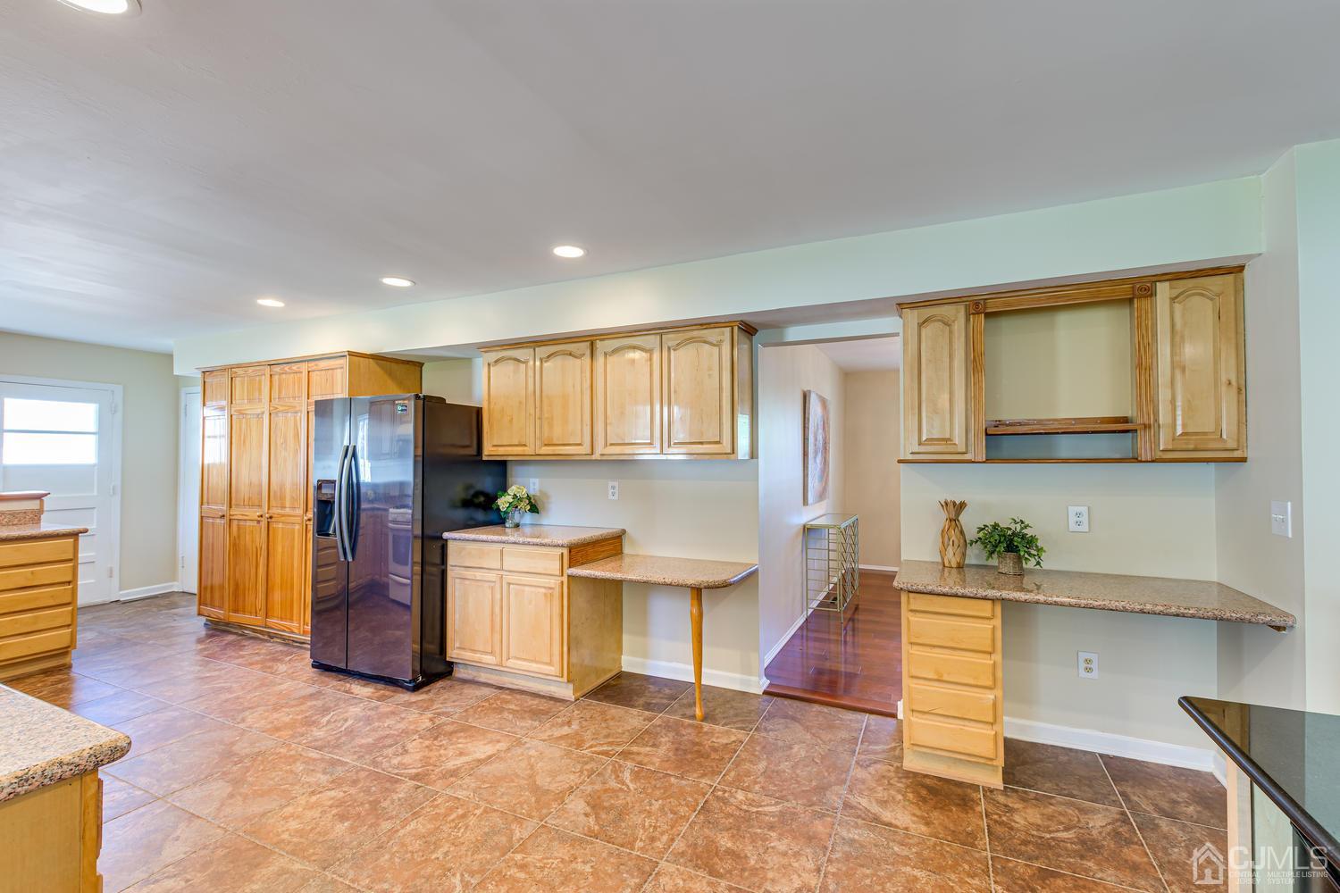 799 New Dover Road Edison, NJ 08820 - Photo 23 of 54 a kitchen with a refrigerator and a sink
