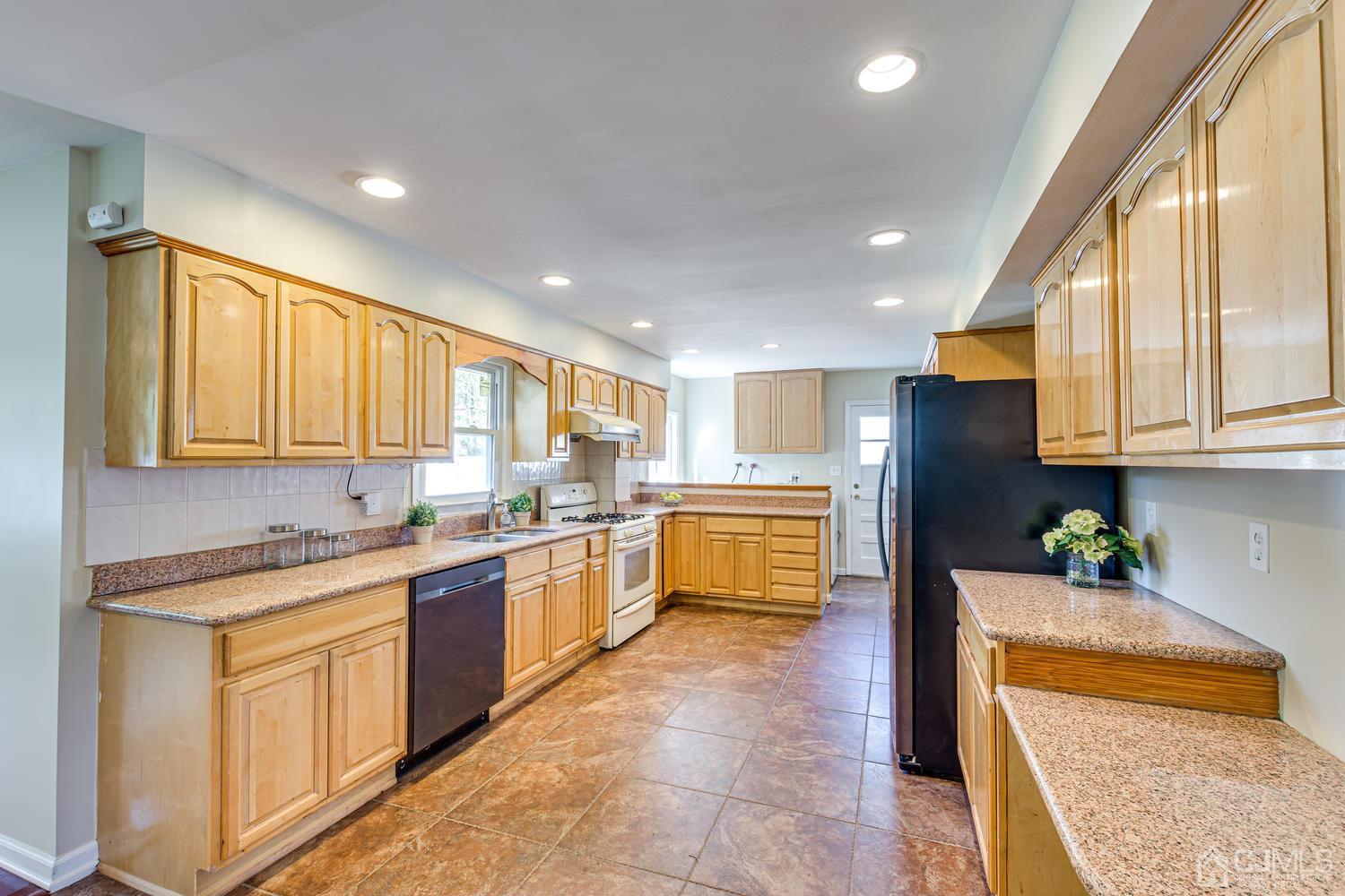 799 New Dover Road Edison, NJ 08820 - Photo 24 of 54 a kitchen with stainless steel appliances granite countertop a refrigerator sink and cabinets