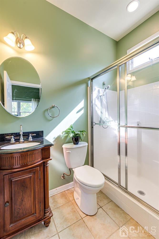 799 New Dover Road Edison, NJ 08820 - Photo 30 of 54 a bathroom with a sink mirror vanity and toilet