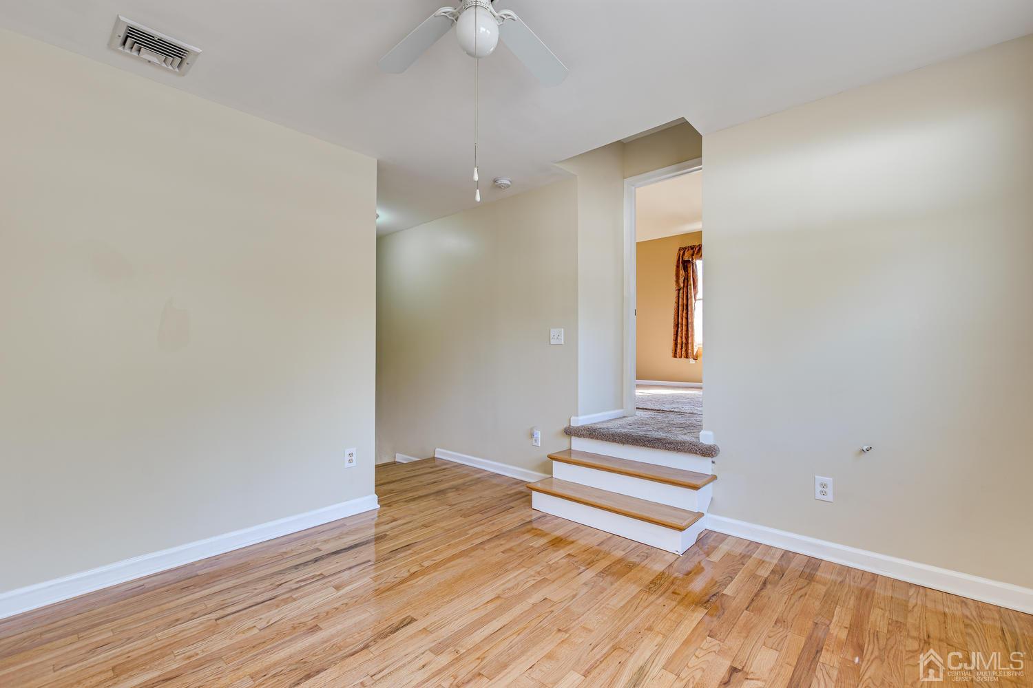 799 New Dover Road Edison, NJ 08820 - Photo 31 of 54 a view of a livingroom with wooden floor and white walls