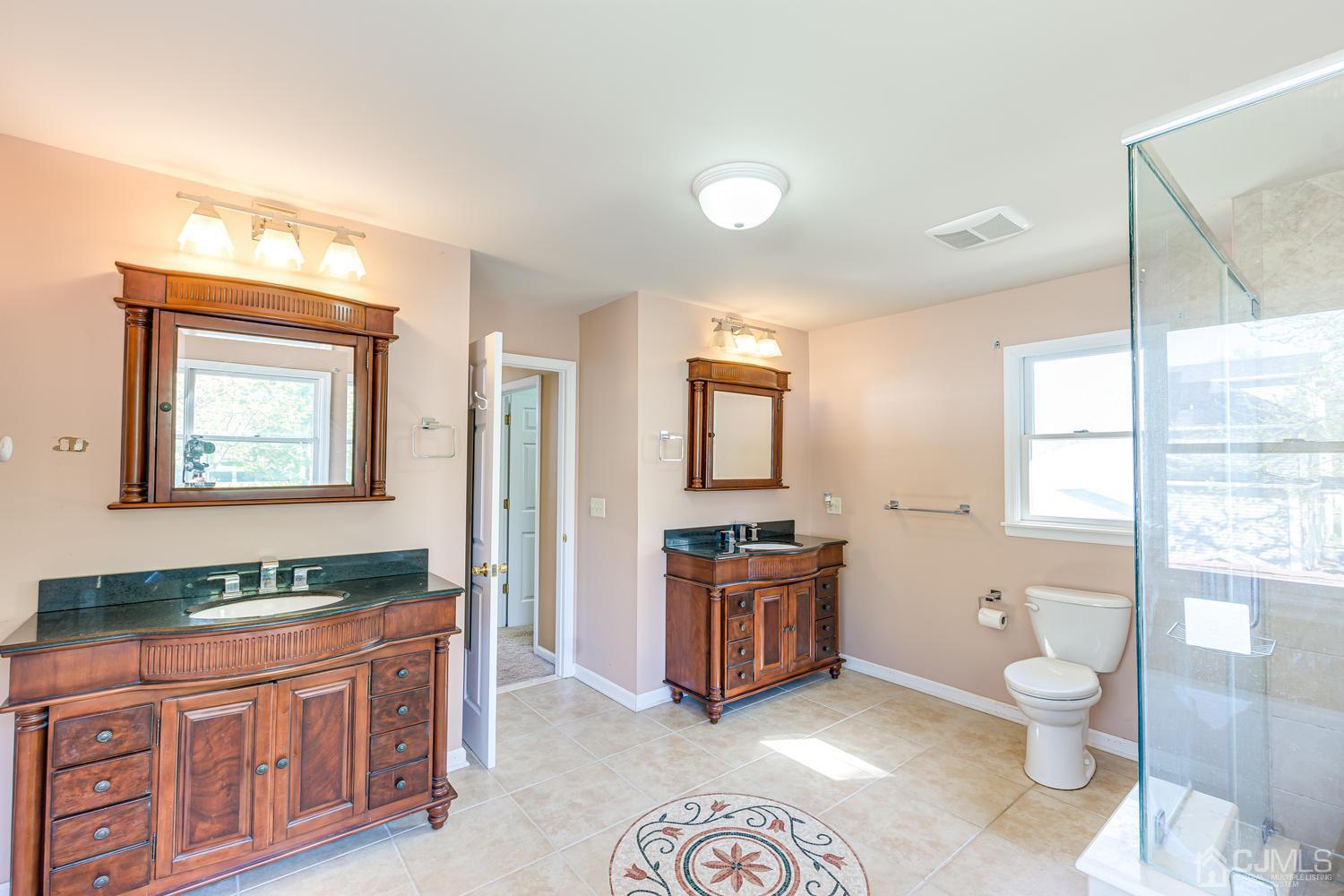 799 New Dover Road Edison, NJ 08820 - Photo 36 of 54 a spacious bathroom with a double vanity sink a toilet and a window