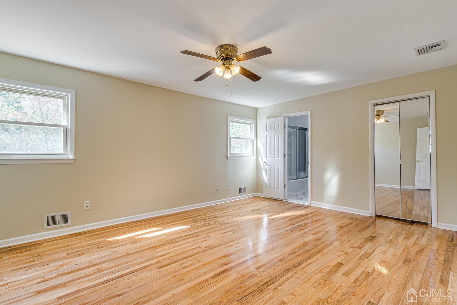 799 New Dover Road Edison, NJ 08820 - Photo 38 of 54 a view of empty room with wooden floor and fan