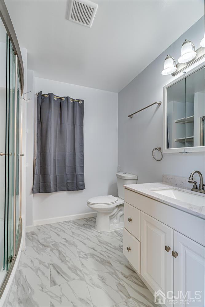 799 New Dover Road Edison, NJ 08820 - Photo 39 of 54 a bathroom with a sink a toilet and mirror