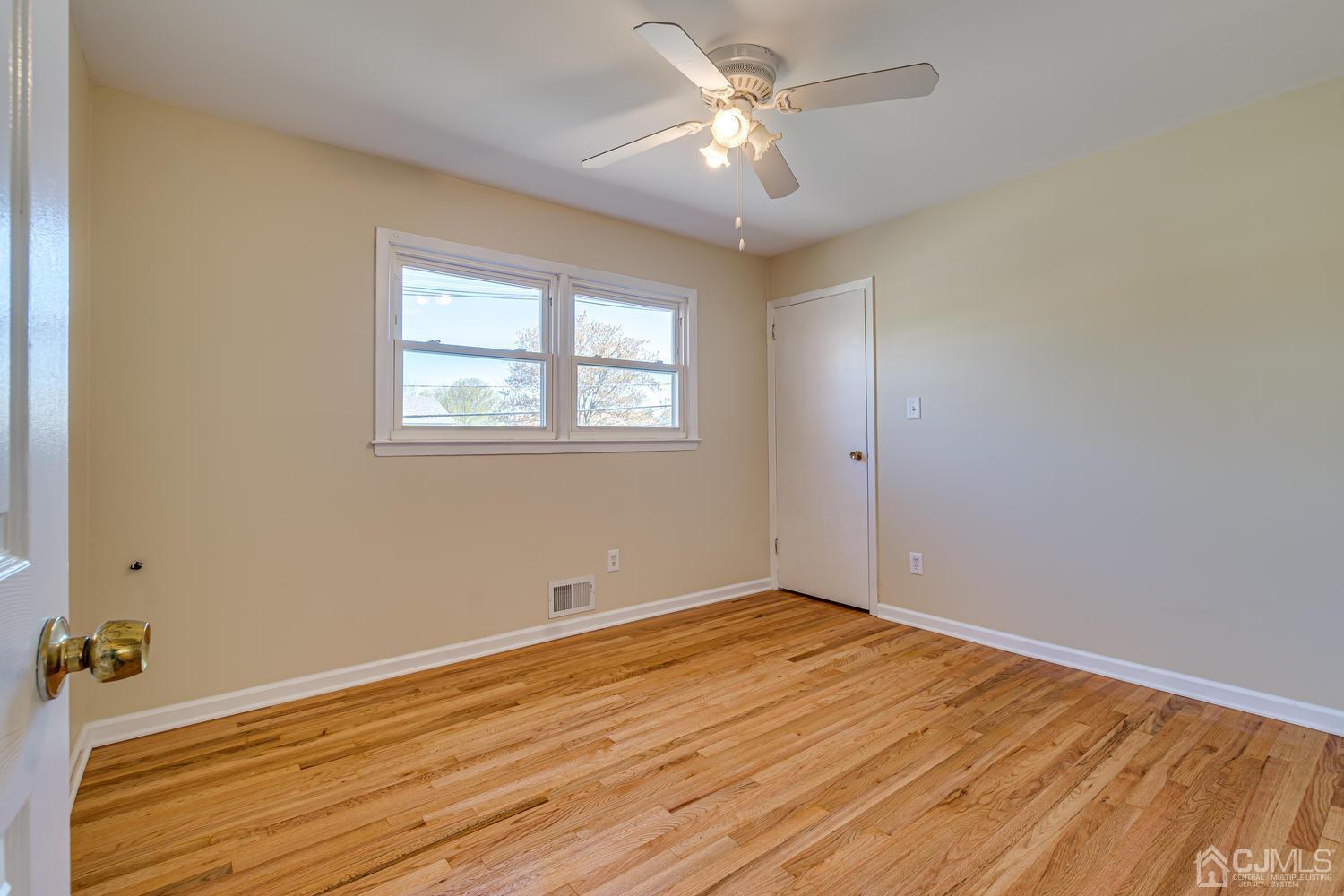799 New Dover Road Edison, NJ 08820 - Photo 41 of 54 a view of empty room with wooden floor and fan